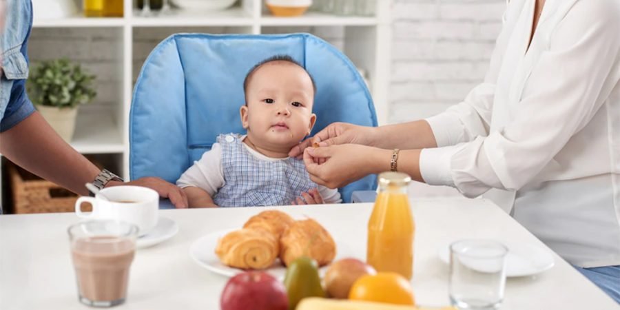 feeding mistakes - feeding the baby - solid food - family meals - bib - high chair - infant nutrition